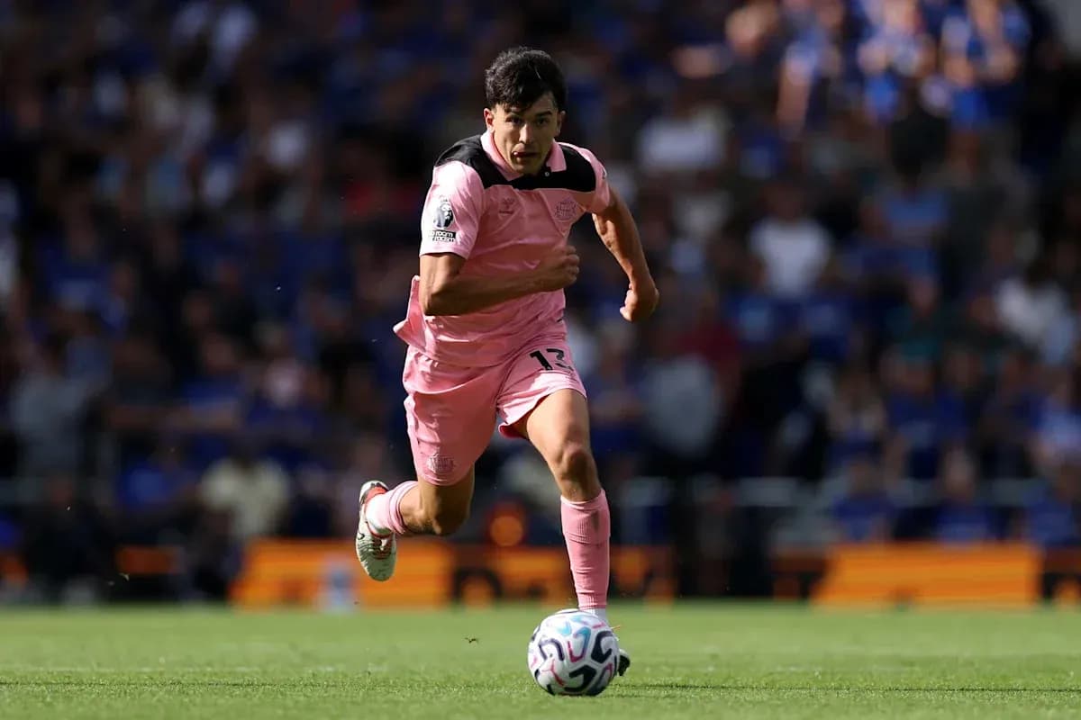 Player in pink jersey sprinting with ball during match Player in pink jersey sprinting with ball during match