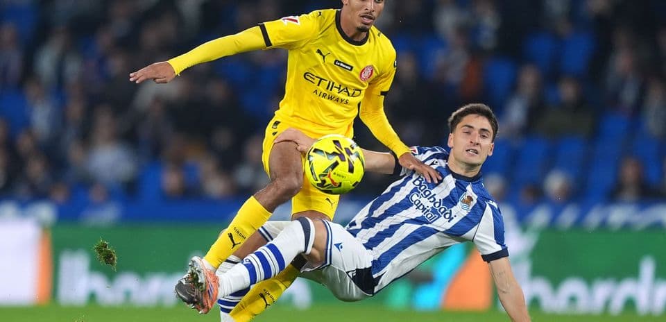 Player tackling during Girona vs Real Sociedad match Player tackling during Girona vs Real Sociedad match