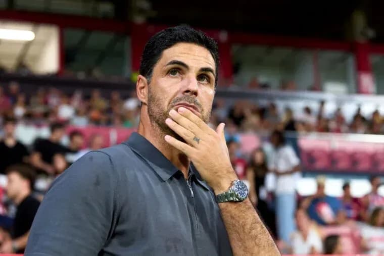 Manager observing the match with fans in background Manager observing the match with fans in background