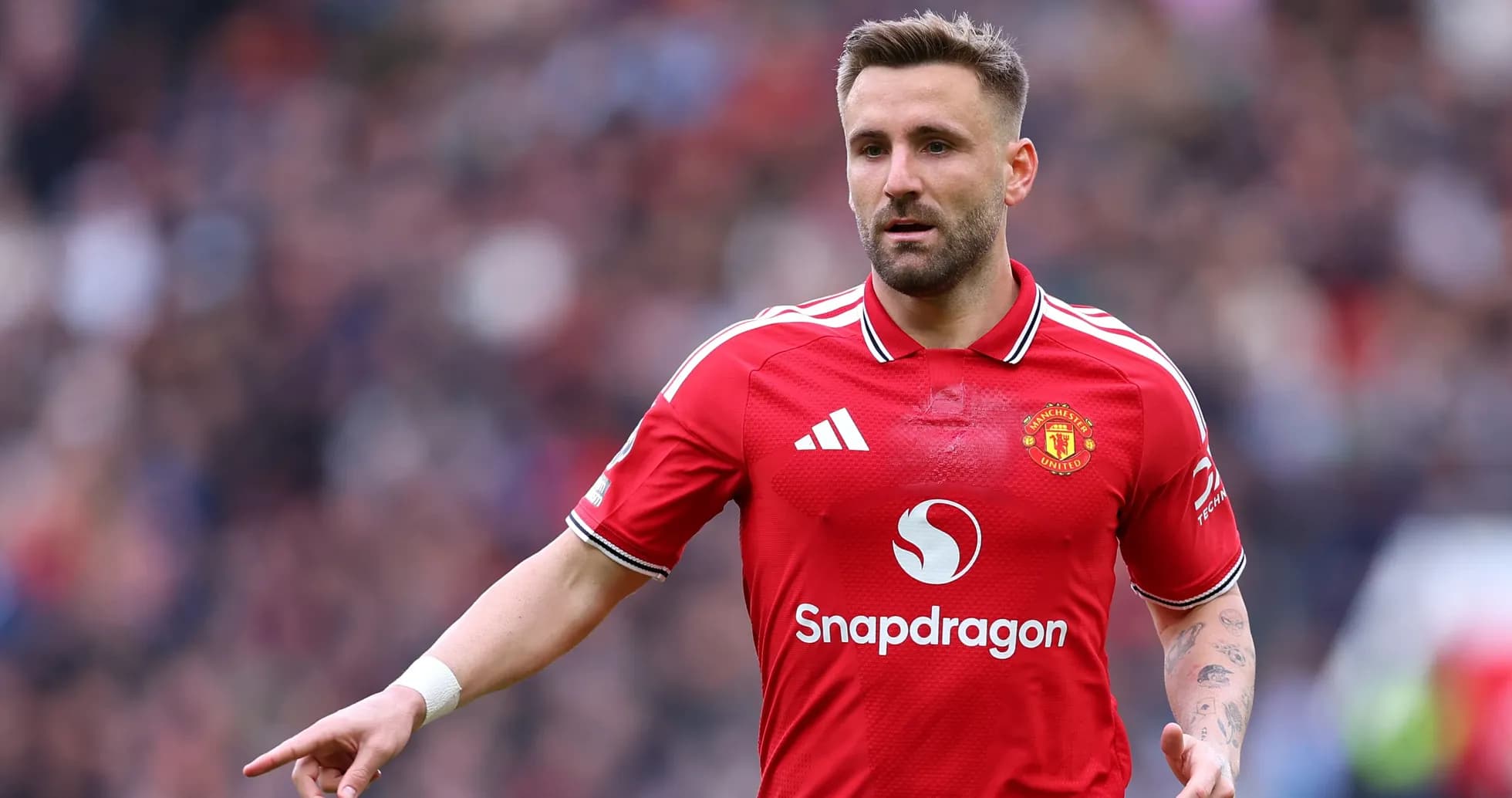 Player in Manchester United kit gesturing on field Player in Manchester United kit gesturing on field