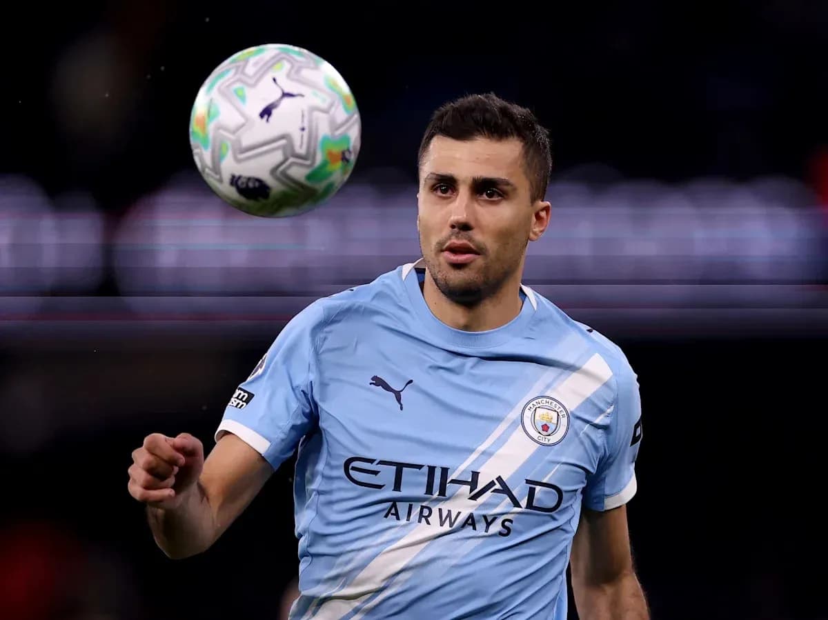 Player in light blue jersey controlling a soccer ball Player in light blue jersey controlling a soccer ball