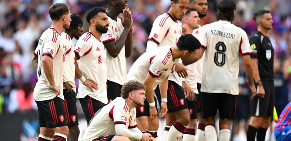 Players from Liverpool FC in a defensive wall Players from Liverpool FC in a defensive wall
