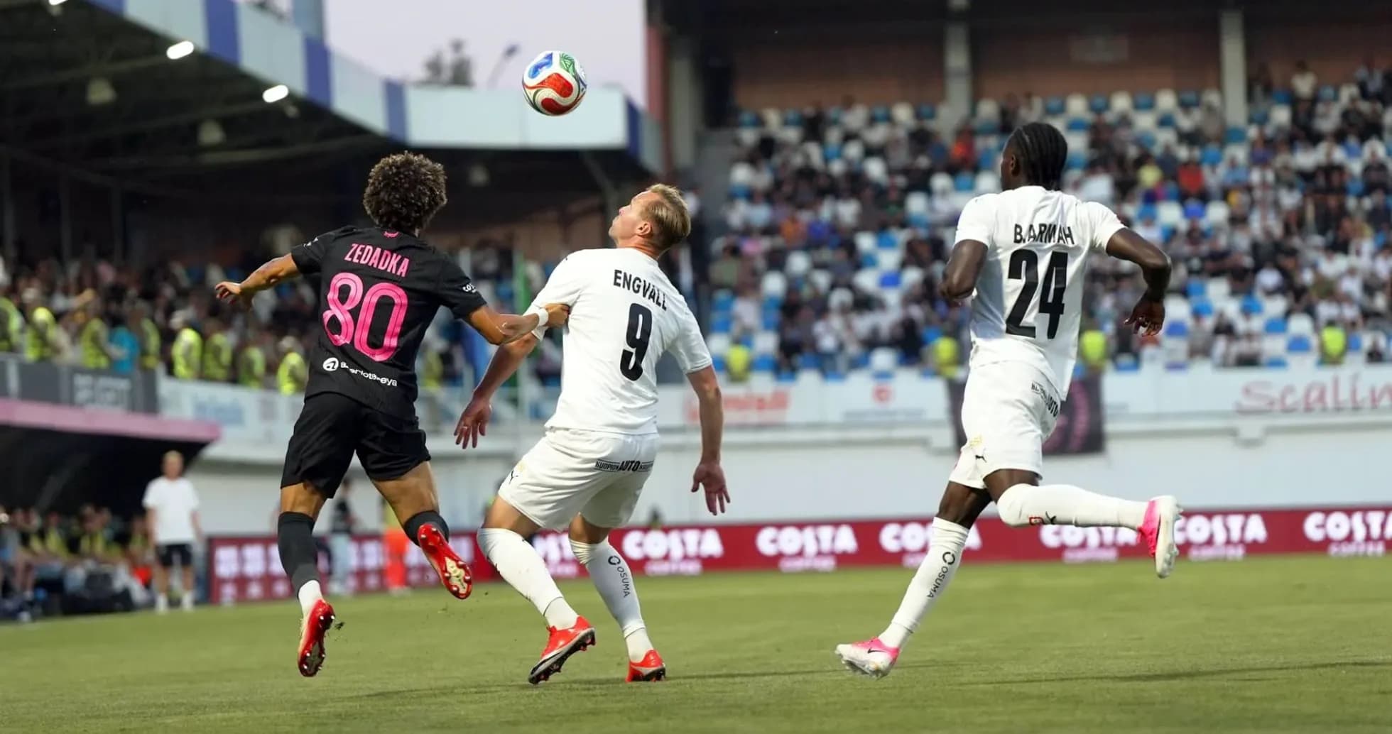 Players contesting a high ball during match Players contesting a high ball during match
