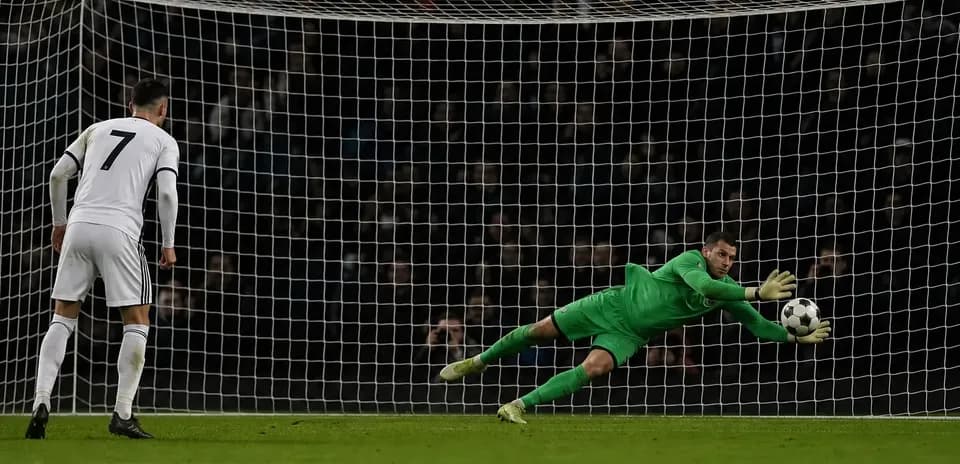 Goalkeeper diving to save a penalty kick Goalkeeper diving to save a penalty kick