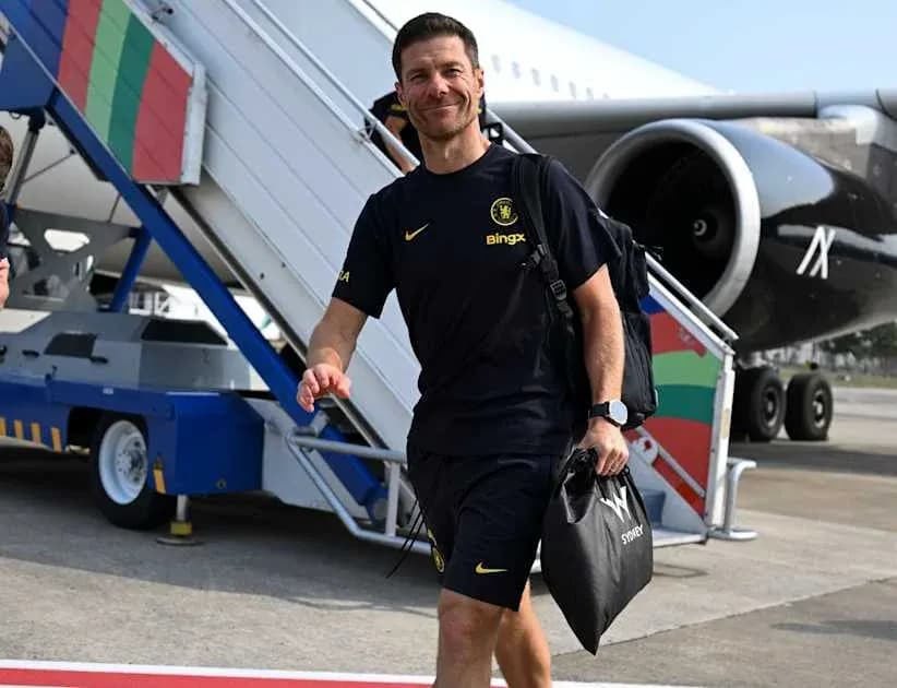 Coach walking down airplane stairs at airport Coach walking down airplane stairs at airport