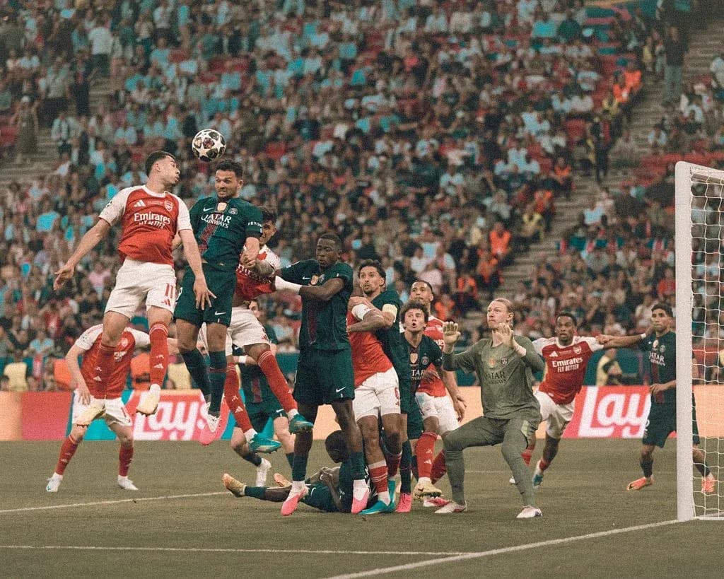 Players contesting for a header in crowded penalty area Players contesting for a header in crowded penalty area