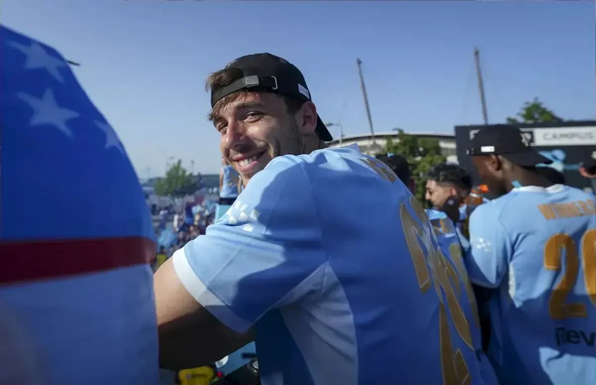 Player smiling during celebration with teammates Player smiling during celebration with teammates