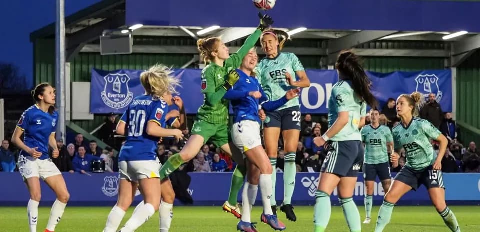 Goalkeeper attempting to catch the ball during match Goalkeeper attempting to catch the ball during match