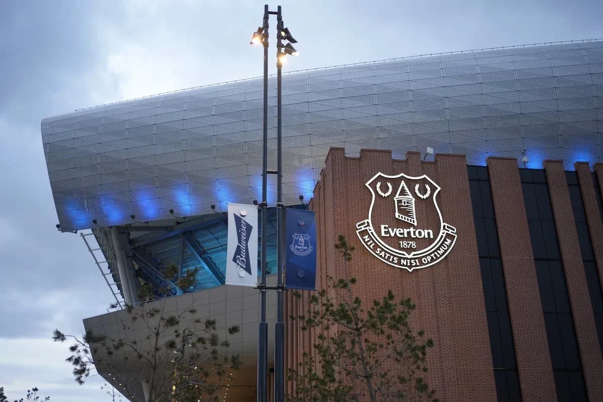Everton FC logo on stadium exterior at dusk Everton FC logo on stadium exterior at dusk