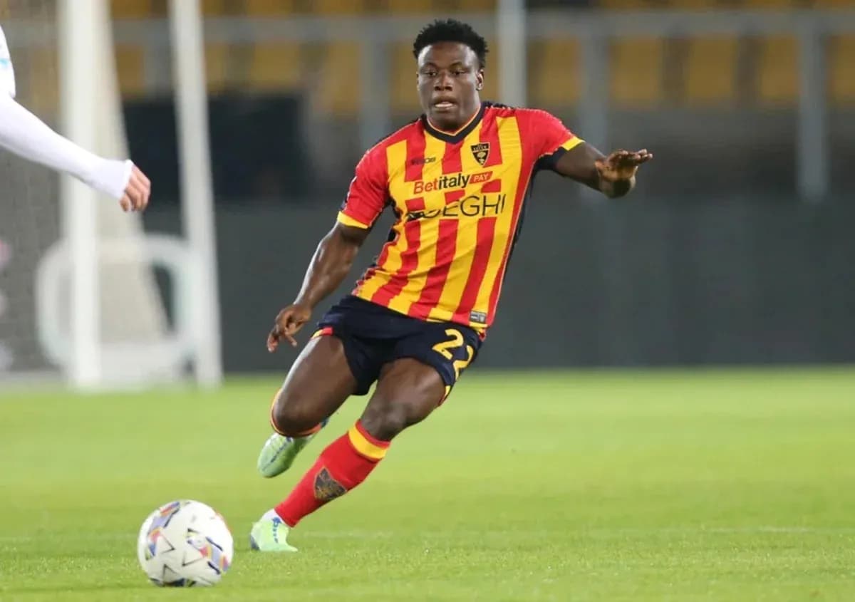 Player in yellow and red jersey dribbling ball on field Player in yellow and red jersey dribbling ball on field