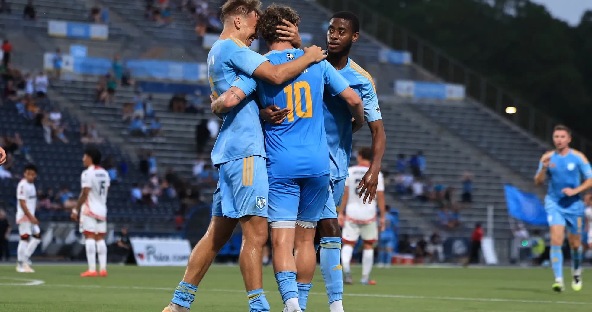 Players celebrating a goal during JAX match Players celebrating a goal during JAX match