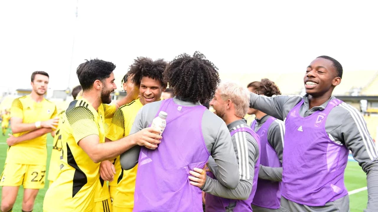 Columbus Crew II players celebrating together Columbus Crew II players celebrating together
