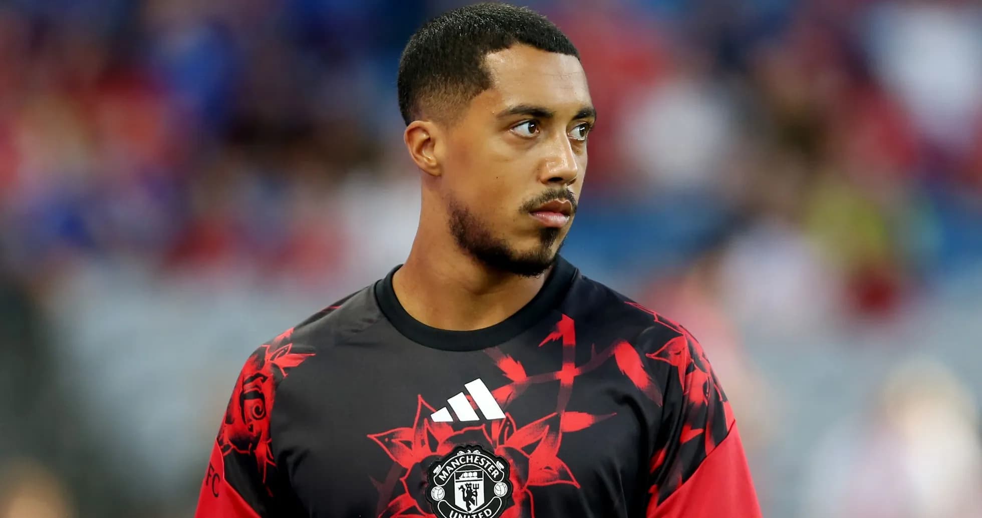 Player in Manchester United training jersey on field Player in Manchester United training jersey on field