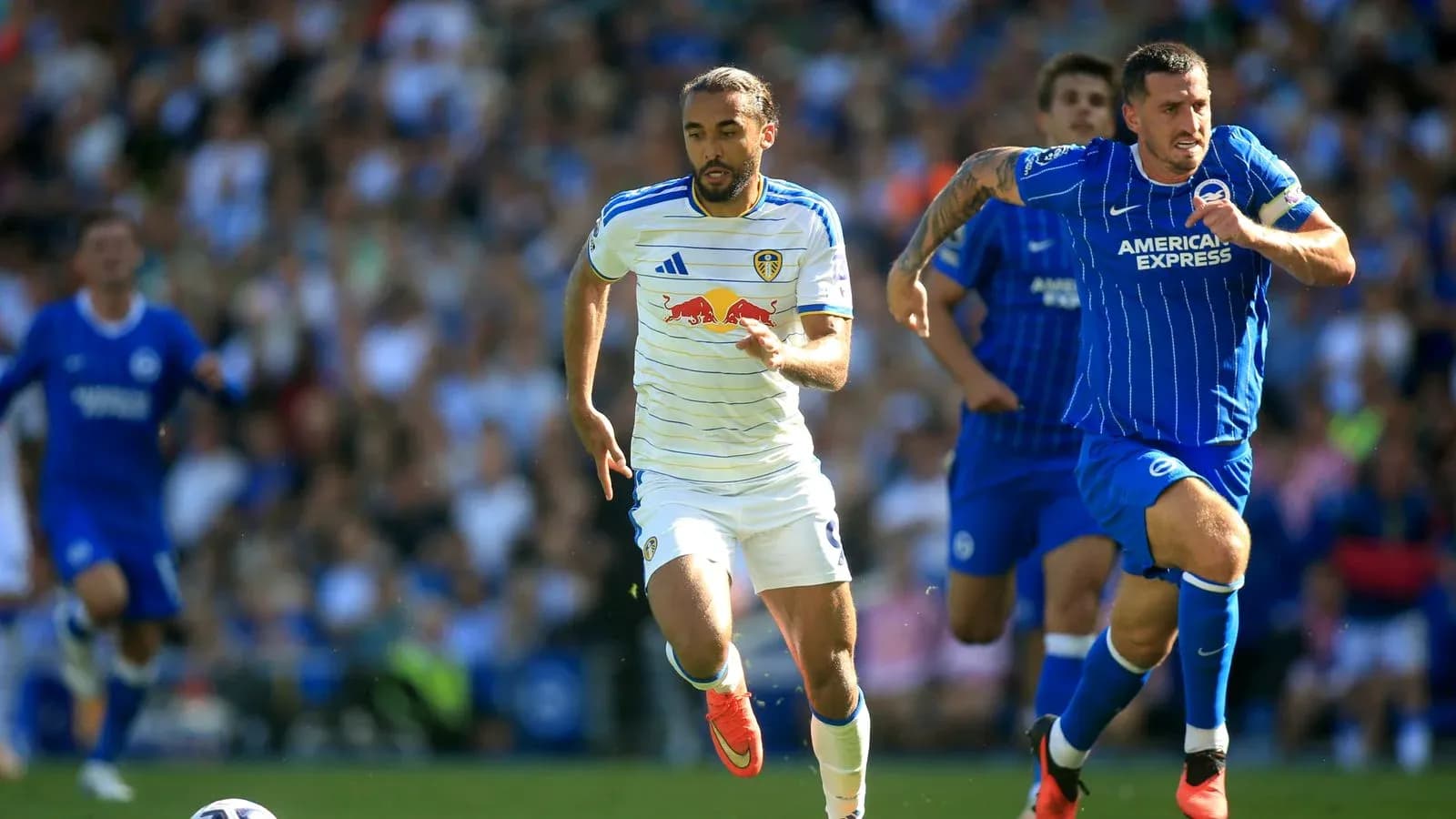Leeds player sprinting with ball, Brighton defender chasing Leeds player sprinting with ball, Brighton defender chasing