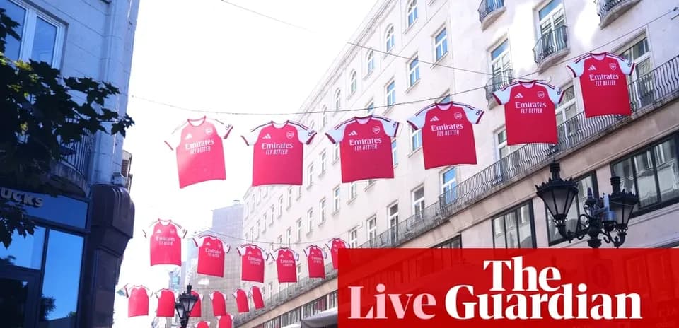 Arsenal jerseys hanging between buildings in city street Arsenal jerseys hanging between buildings in city street
