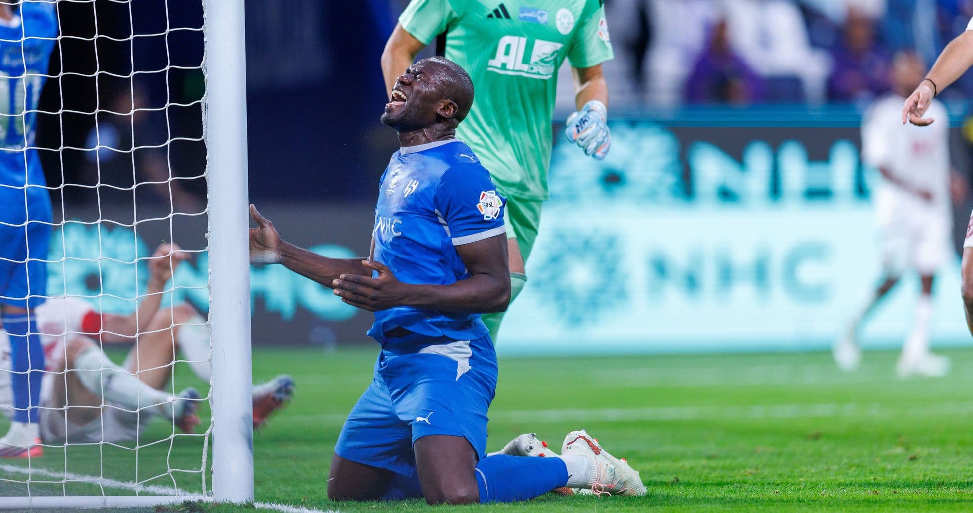 Player kneeling near goal after missed chance Player kneeling near goal after missed chance