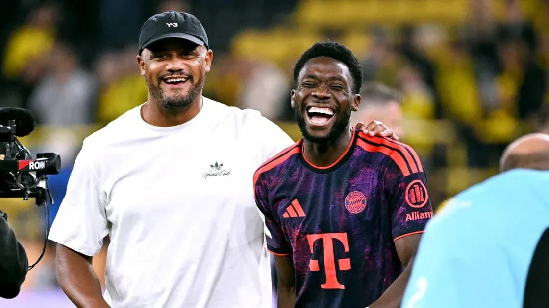 Two men laughing on the football field post-match Two men laughing on the football field post-match