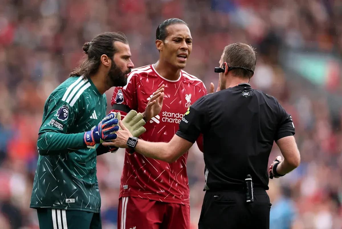 Liverpool players discussing with referee during match Liverpool players discussing with referee during match