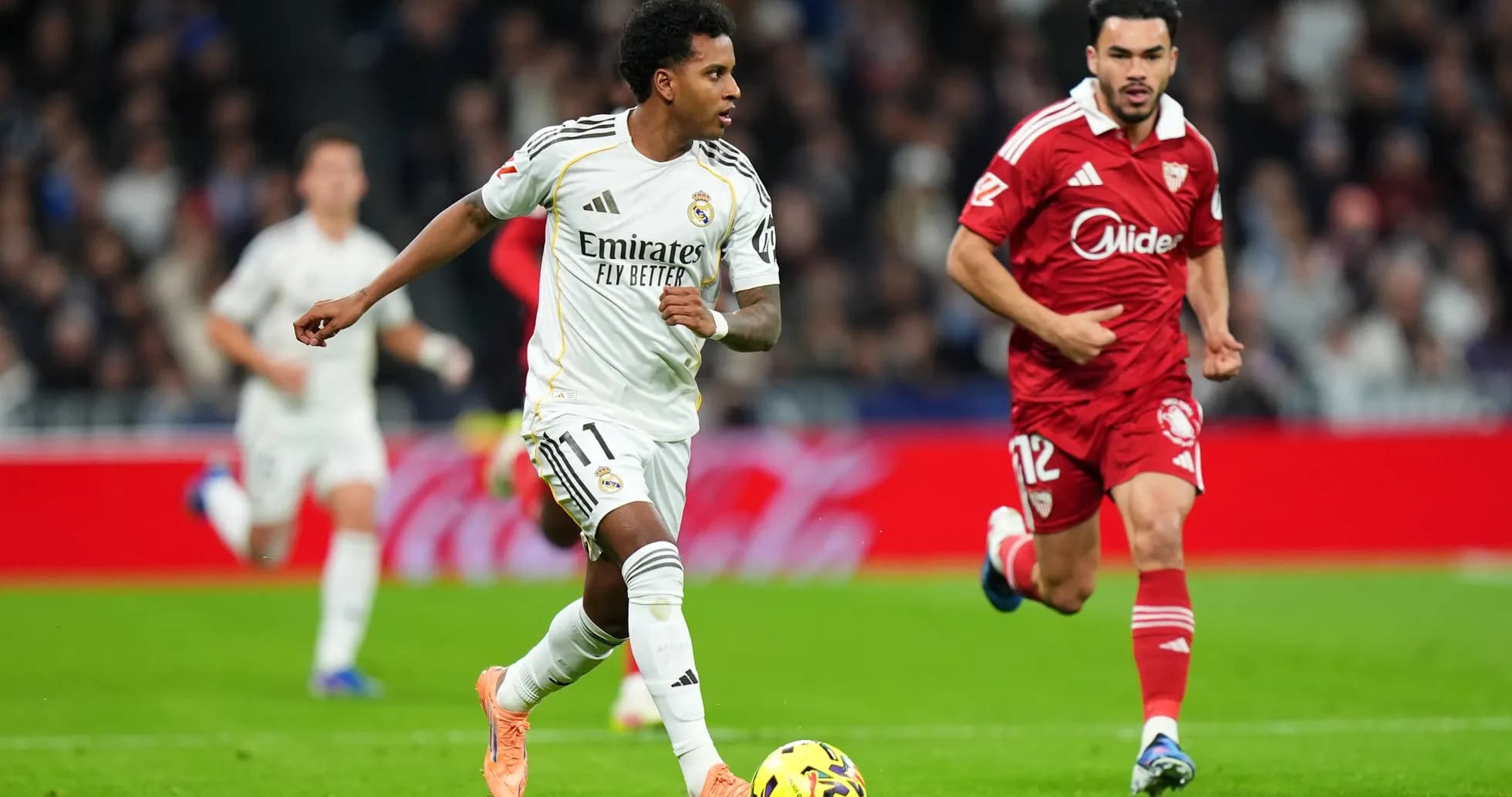 Real Madrid player dribbling past Sevilla defender Real Madrid player dribbling past Sevilla defender