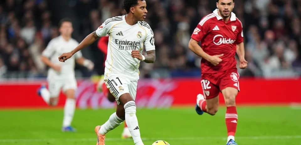Real Madrid player dribbling past Sevilla defender Real Madrid player dribbling past Sevilla defender