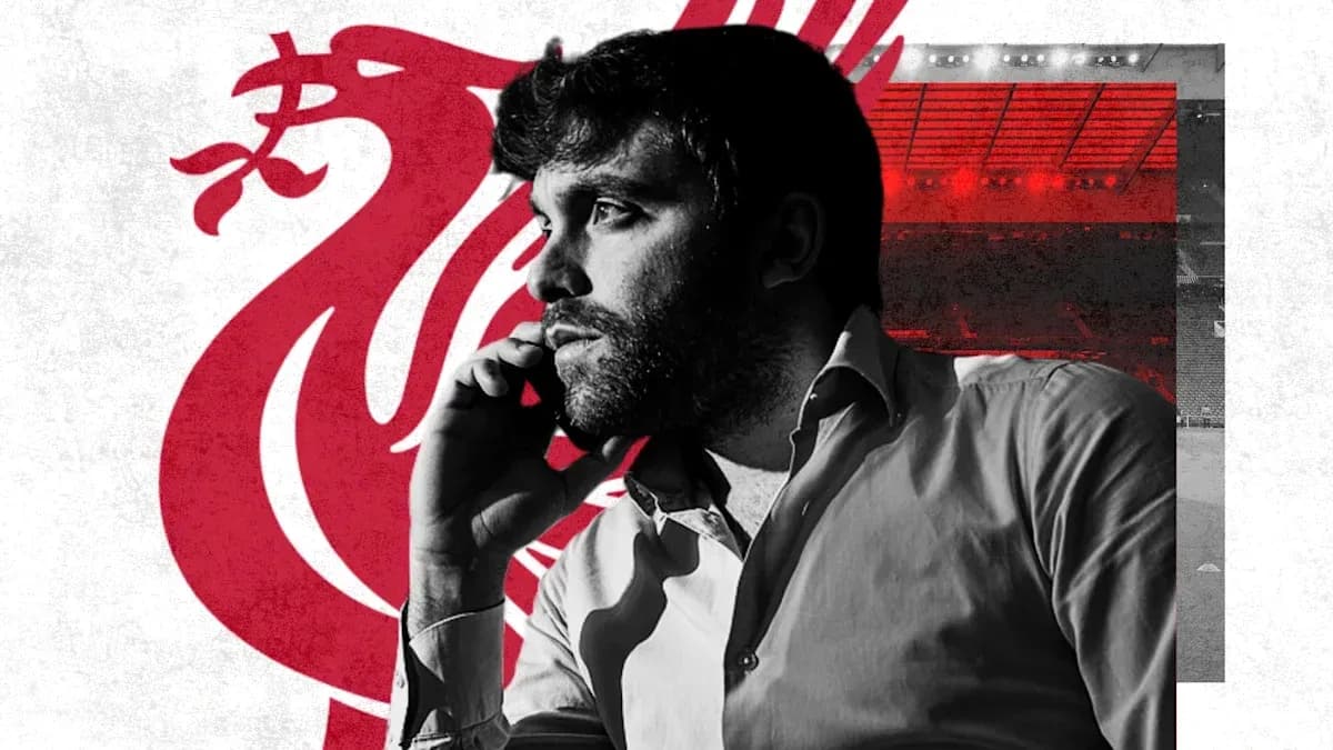 Man on phone with Liverpool logo in background Man on phone with Liverpool logo in background