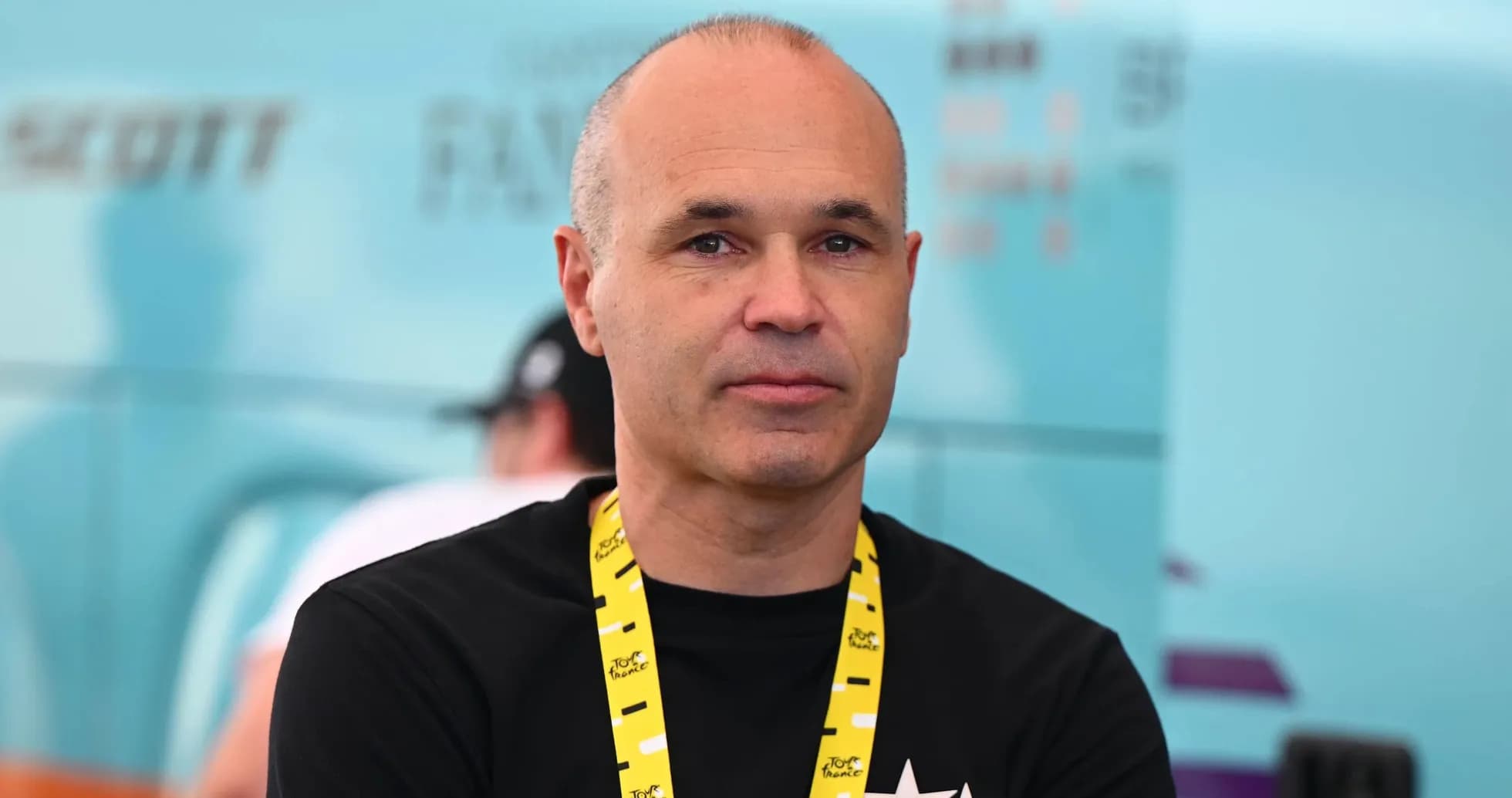 Man with yellow lanyard at cycling event Man with yellow lanyard at cycling event