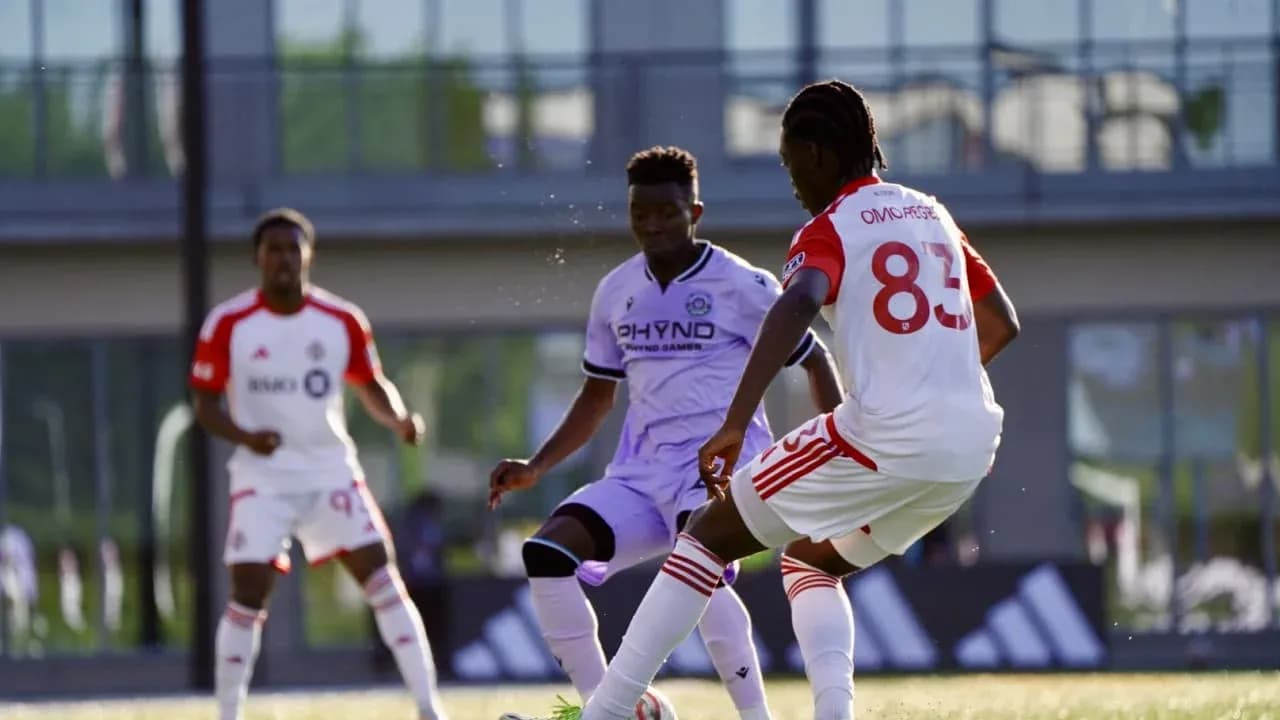 Toronto II player dribbling past Connecticut FC opponent Toronto II player dribbling past Connecticut FC opponent