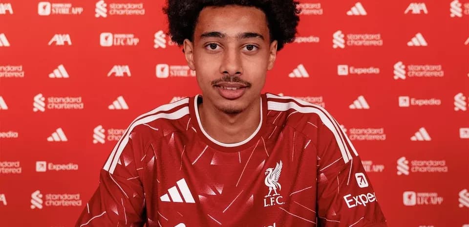 Player signing contract in Liverpool FC kit Player signing contract in Liverpool FC kit