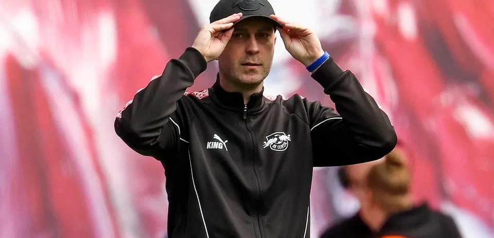 Coach adjusting cap during match on sidelines Coach adjusting cap during match on sidelines