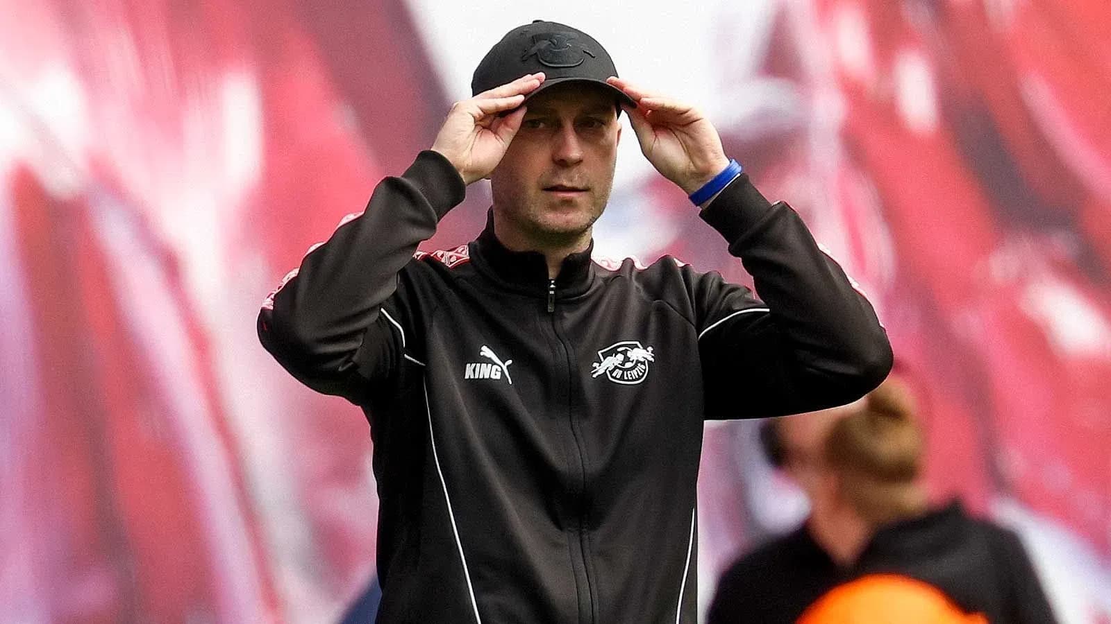 Coach adjusting cap during match on sidelines Coach adjusting cap during match on sidelines