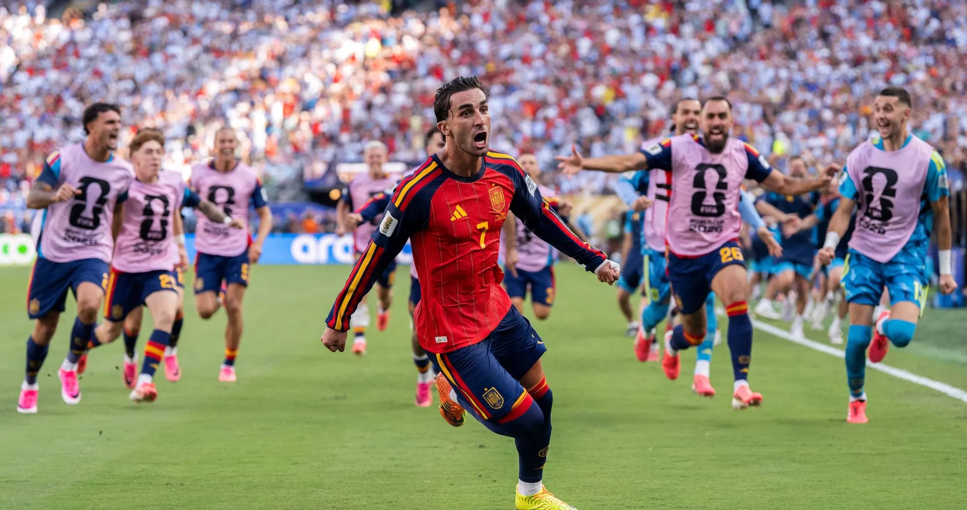 Spanish player celebrating goal with teammates on field Spanish player celebrating goal with teammates on field