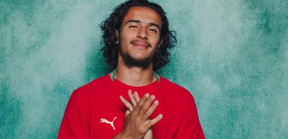 Athlete posing in red jersey with hands together Athlete posing in red jersey with hands together