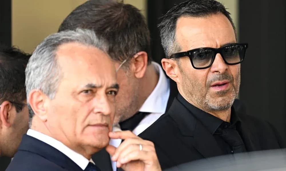 Two men in suits at a public event Two men in suits at a public event