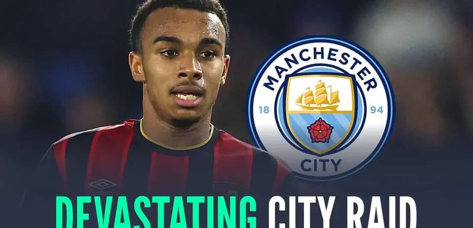 Player in black and red jersey with Manchester City logo Player in black and red jersey with Manchester City logo