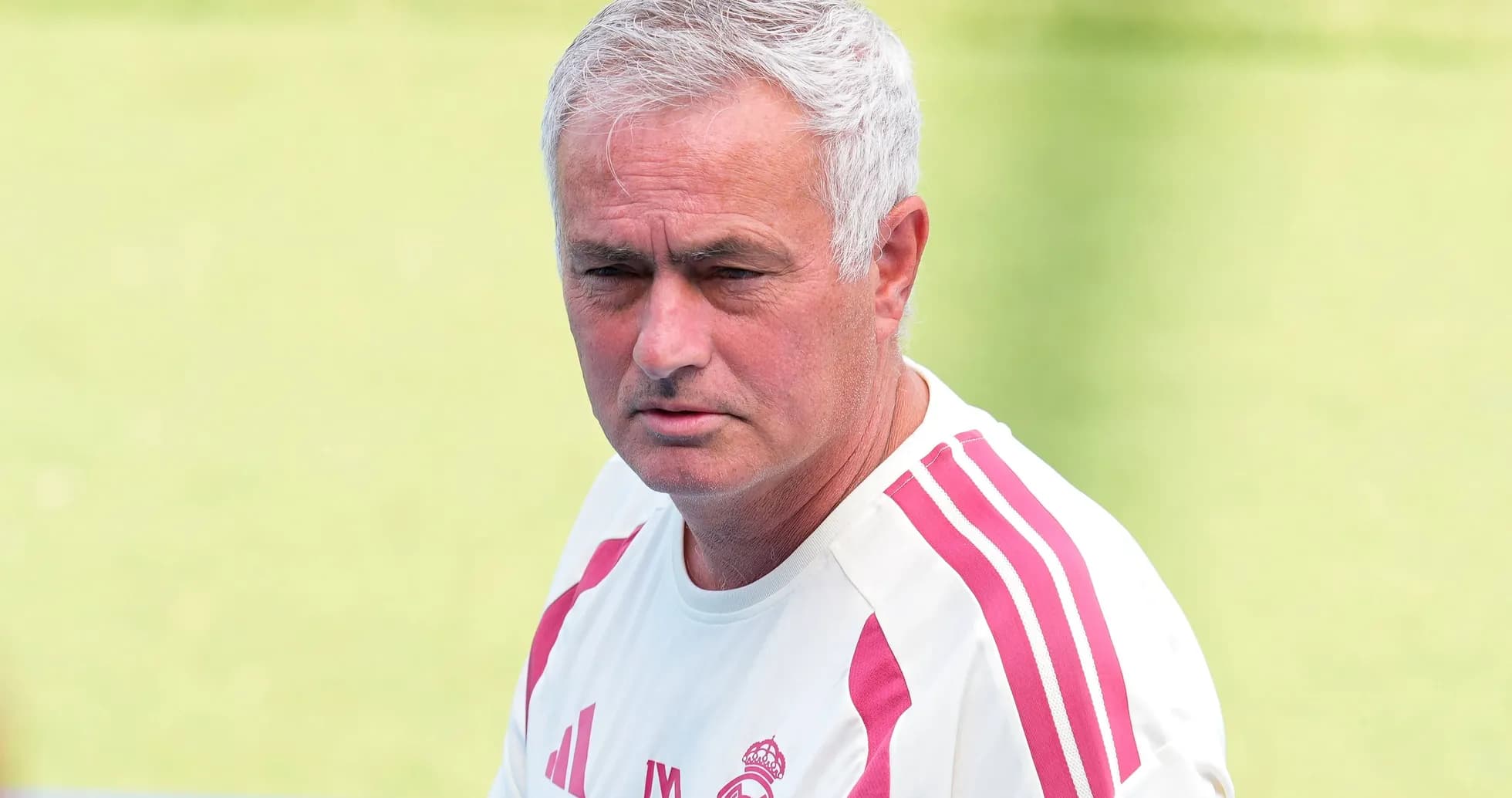 Coach in training shirt on football pitch Coach in training shirt on football pitch