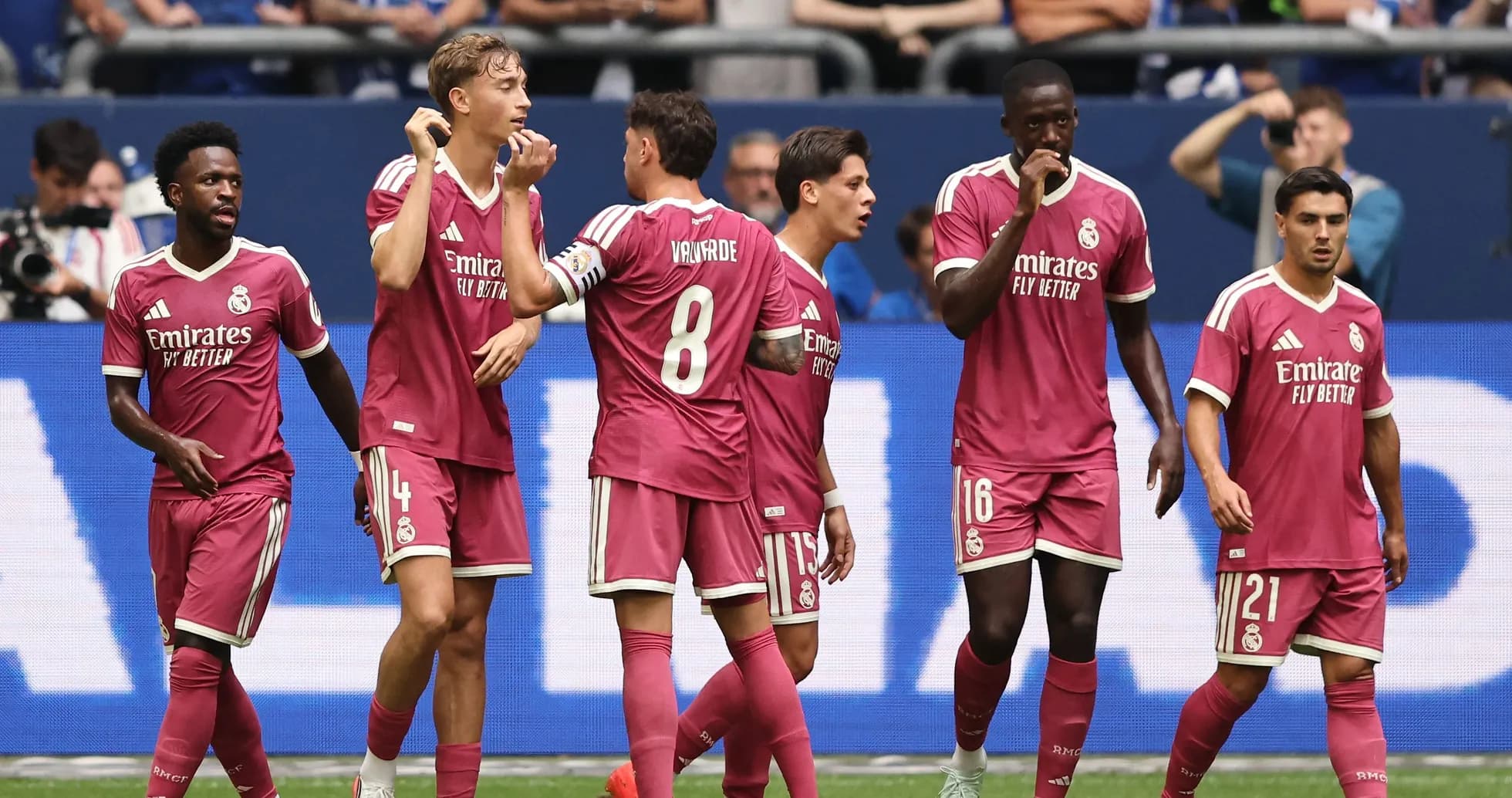 Real Madrid players celebrating during a match Real Madrid players celebrating during a match