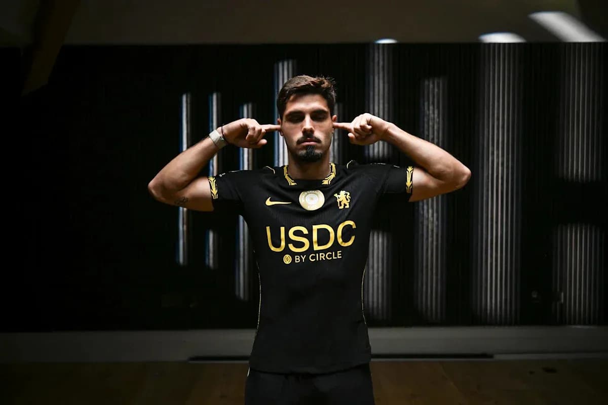 Player posing in black jersey with USDC logo Player posing in black jersey with USDC logo