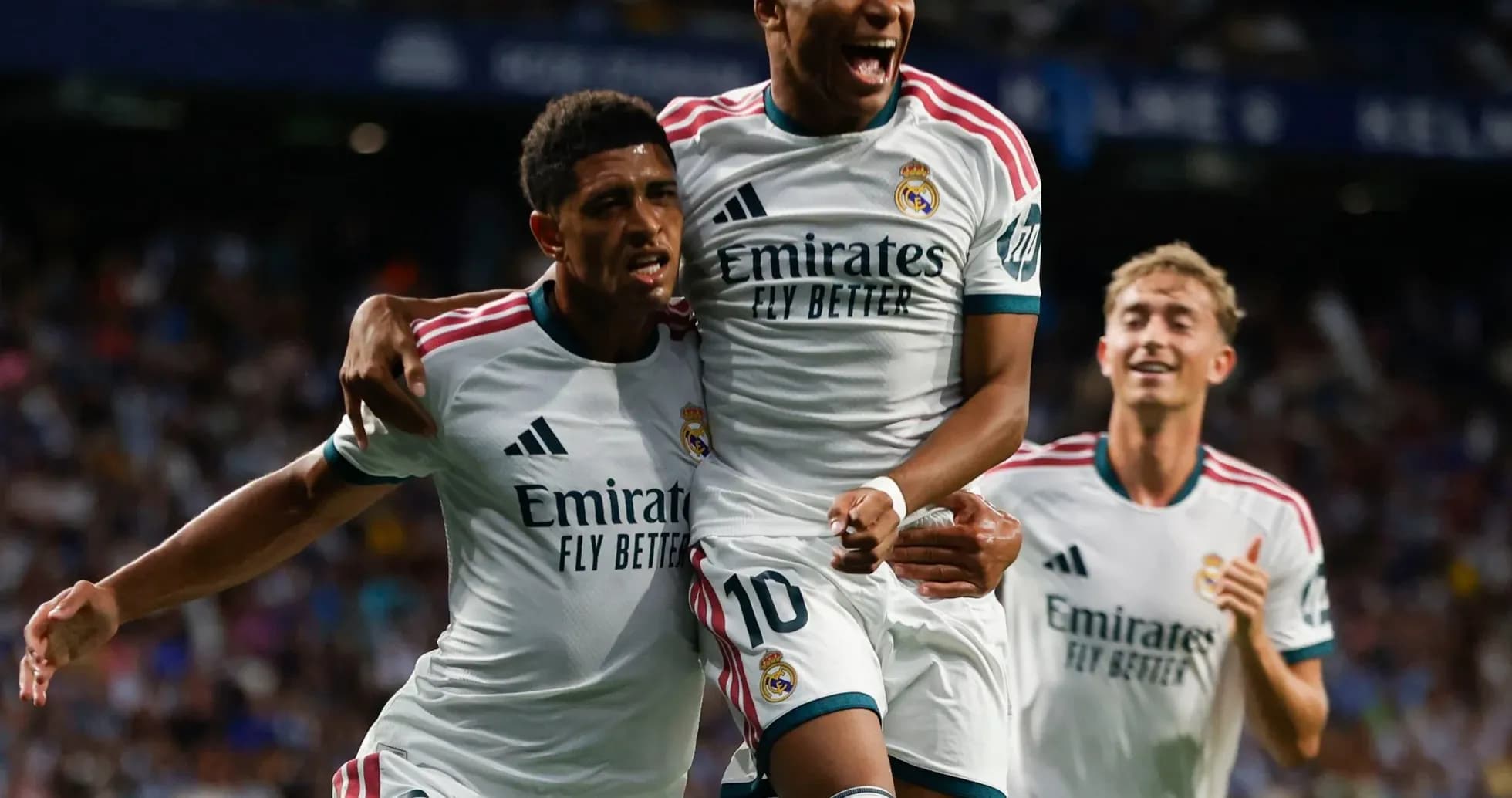Real Madrid players celebrating a goal on field Real Madrid players celebrating a goal on field