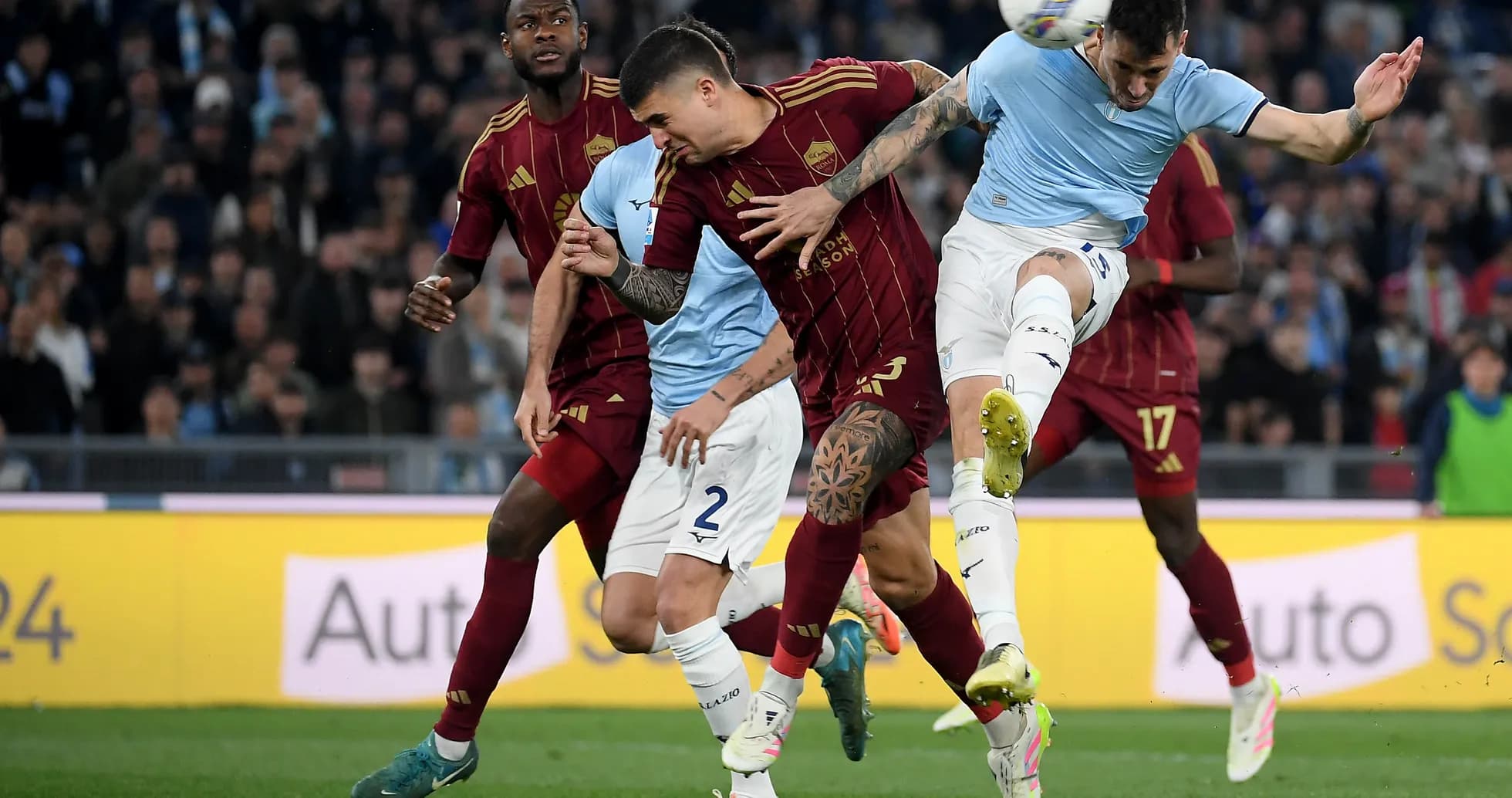 AS Roma and Lazio players contesting for the ball AS Roma and Lazio players contesting for the ball