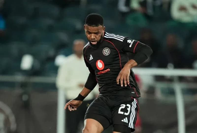 Player in black kit dribbling ball during match Player in black kit dribbling ball during match