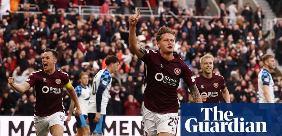 Hearts player celebrating a goal with teammates Hearts player celebrating a goal with teammates