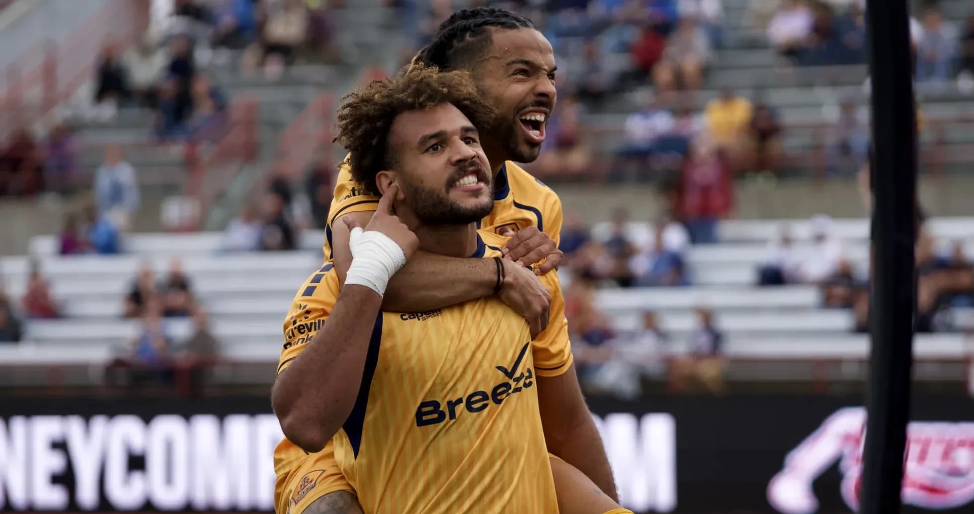 Players celebrating a goal during USL match Players celebrating a goal during USL match
