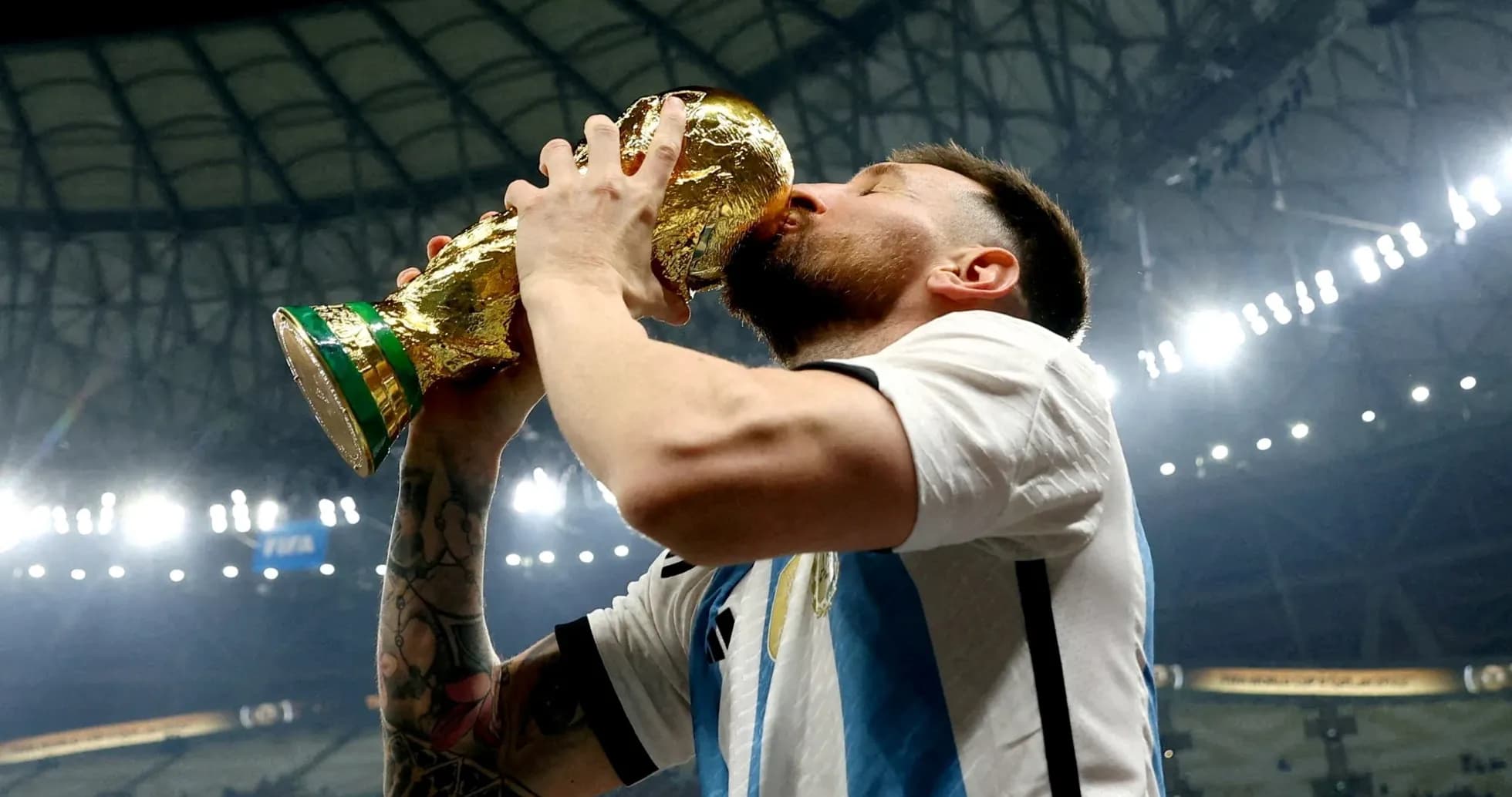 Player celebrating victory by kissing the trophy Player celebrating victory by kissing the trophy