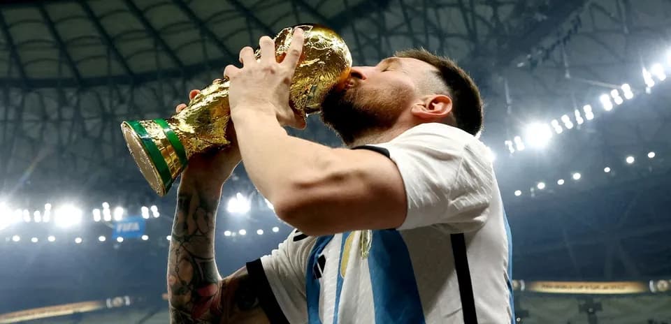 Player celebrating victory by kissing the trophy Player celebrating victory by kissing the trophy