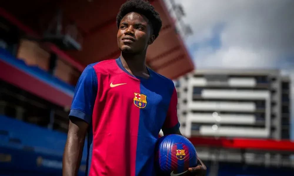 Player holding a ball at Barcelona stadium Player holding a ball at Barcelona stadium