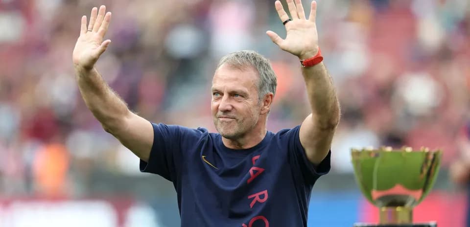 Coach waving to fans next to trophy Coach waving to fans next to trophy