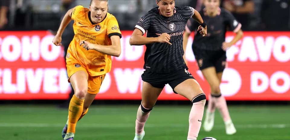 Houston Dash player dribbling past Angel City defender Houston Dash player dribbling past Angel City defender