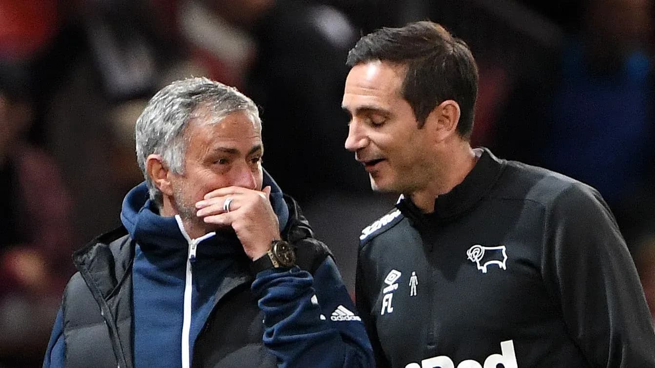 Two football managers conversing on the sidelines Two football managers conversing on the sidelines