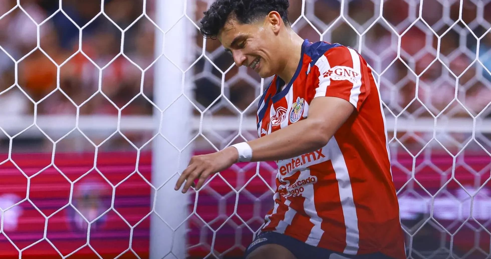 Chivas player celebrating near goalpost Chivas player celebrating near goalpost
