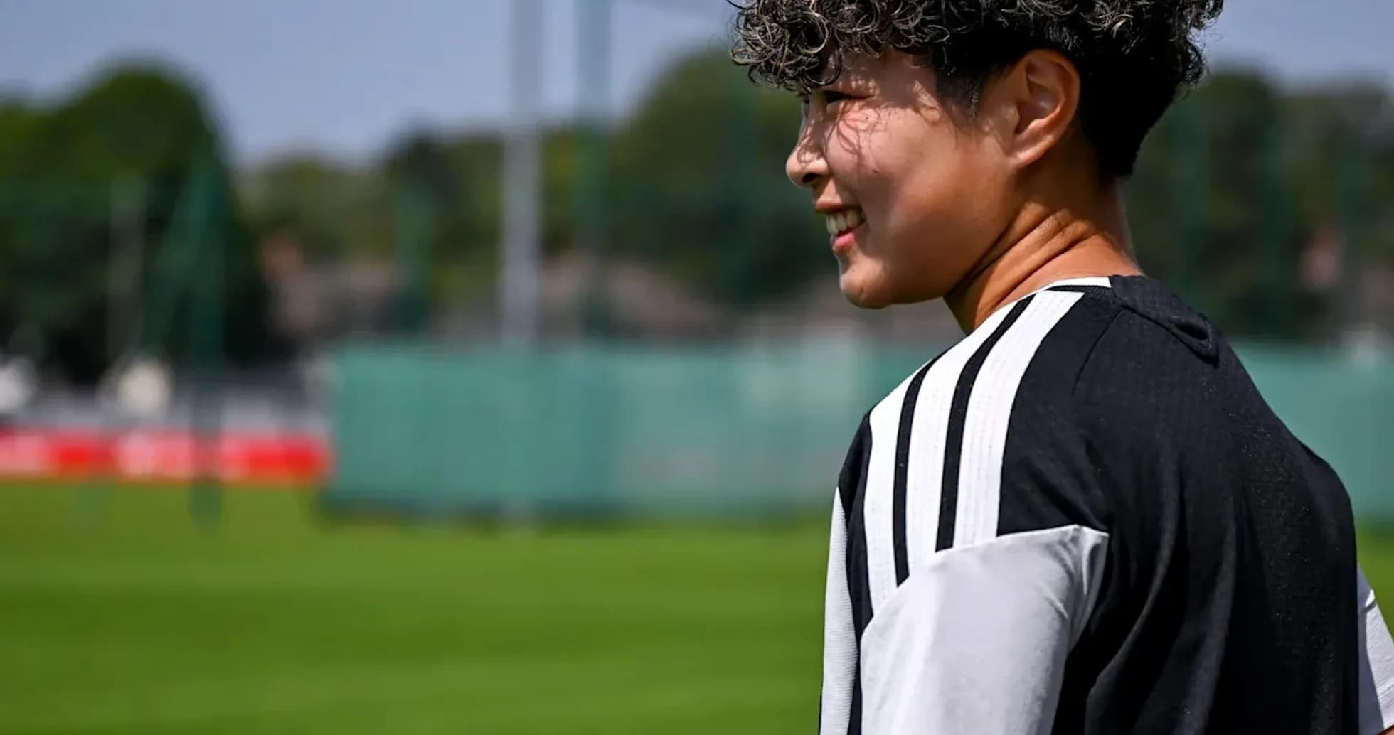 Player walking on training pitch during sunny day Player walking on training pitch during sunny day